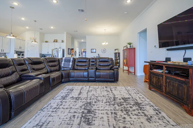 a kitchen with stainless steel appliances a sink a stove a refrigerator and cabinets