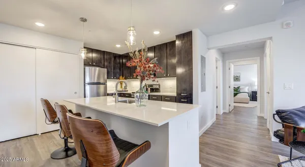 a large kitchen with a table and chairs