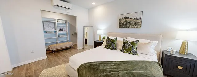 a bedroom with a bed and a television