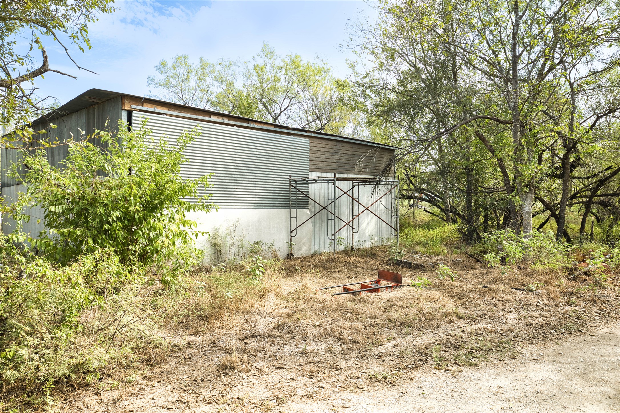 2900 Salt Flat Road Luling, TX 78648 - Photo 14 of 17 An existing outbuilding surrounded by mature trees offers potential on the property grounds.