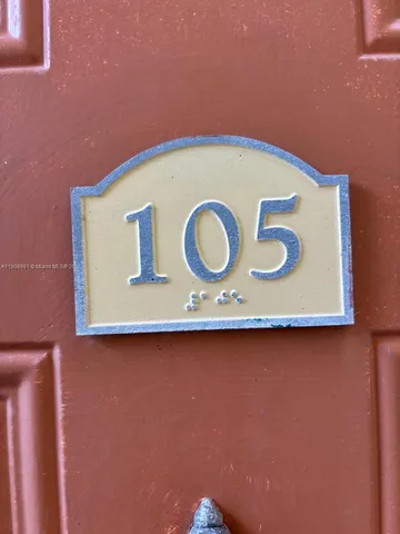 a blue sign sitting on a wooden wall
