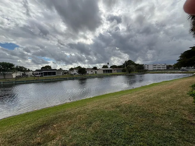 a view of a lake with houses in the background