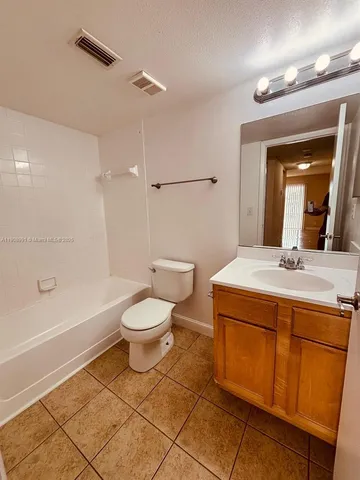 a bathroom with a toilet a sink and bathtub