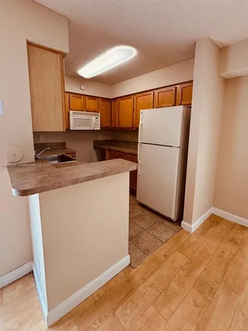 a kitchen with a sink appliances and cabinets