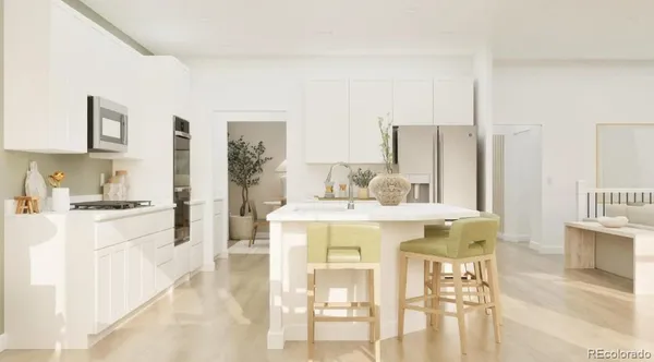 a kitchen with stainless steel appliances kitchen island granite countertop a refrigerator a stove and white cabinets with wooden floor