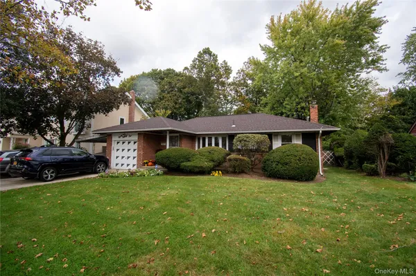 a view of a house with a yard and sitting area