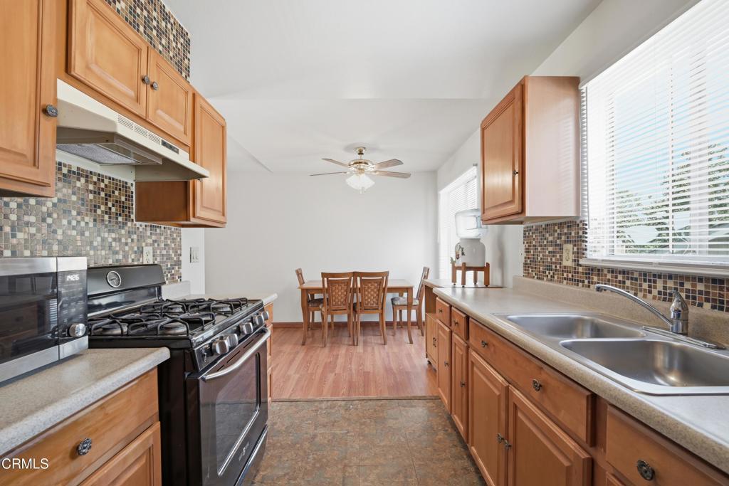 5154 Jefferson Square Oxnard, CA 93033 - Photo 12 of 23 a kitchen with a sink stove and cabinets