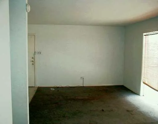 an empty room with an empty space and window