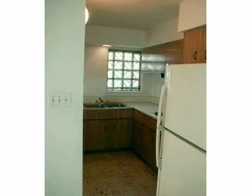 a kitchen with a refrigerator and a sink