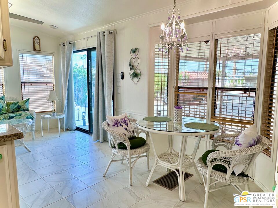 69801 Ramon Road, Unit 192 Cathedral City, CA 92234 - Photo 11 of 18 a living room with furniture and a chandelier
