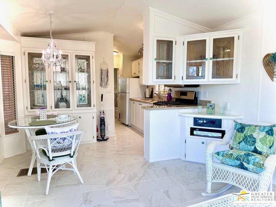 69801 Ramon Road, Unit 192 Cathedral City, CA 92234 - Photo 13 of 18 a kitchen with stainless steel appliances kitchen island granite countertop a refrigerator and cabinets