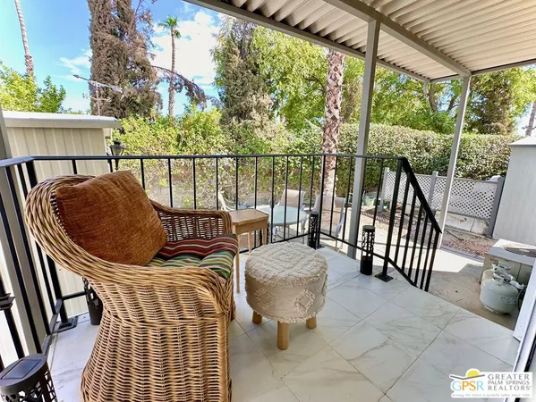 a balcony view with couple of chairs