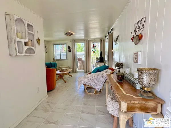 a living room with furniture and large windows