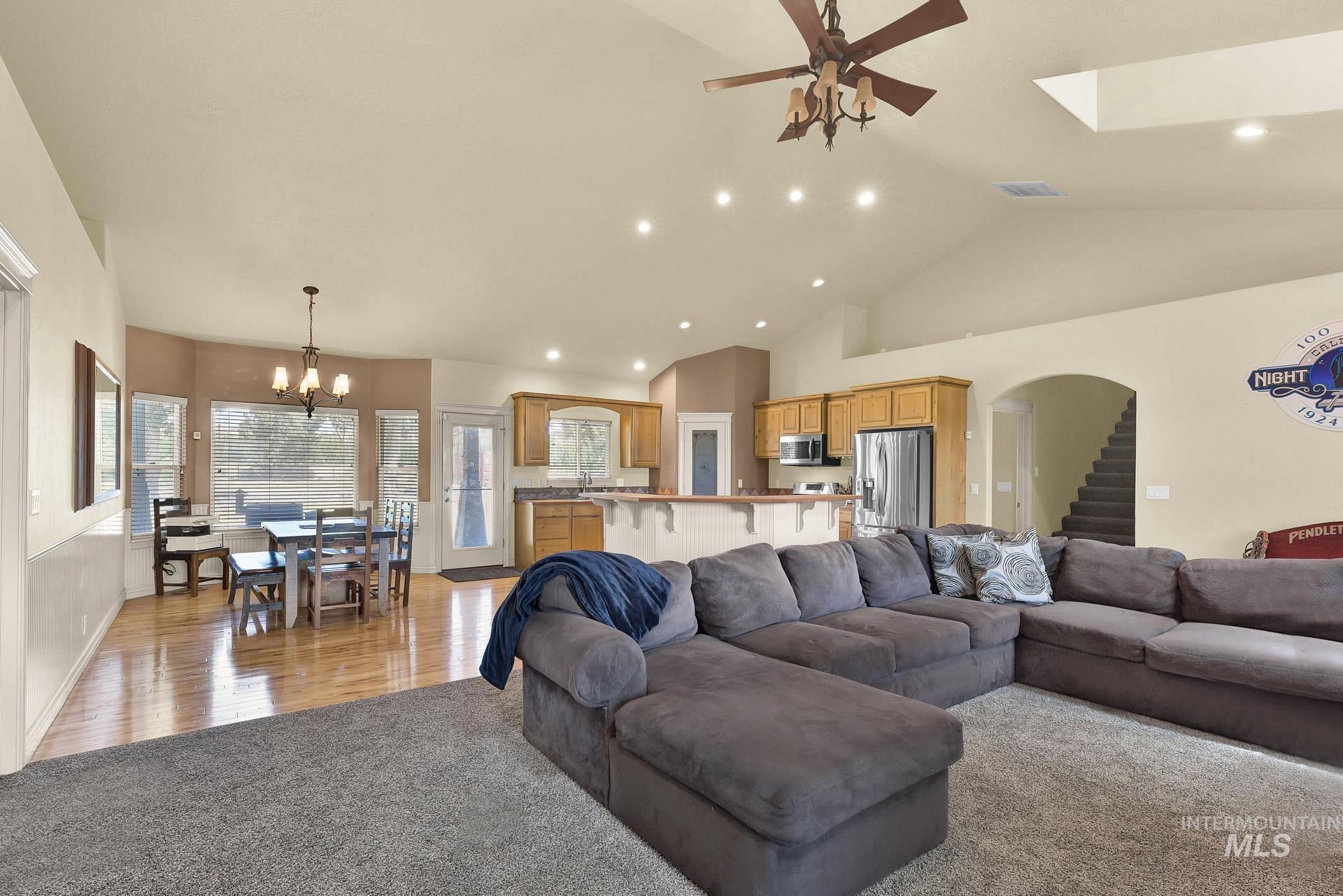 27114 Lower Pleasant Ridge Road Wilder, ID 83676 - Photo 32 of 48 Living room with high vaulted ceiling, a chandelier, light colored carpet, recessed lighting, and a ceiling fan