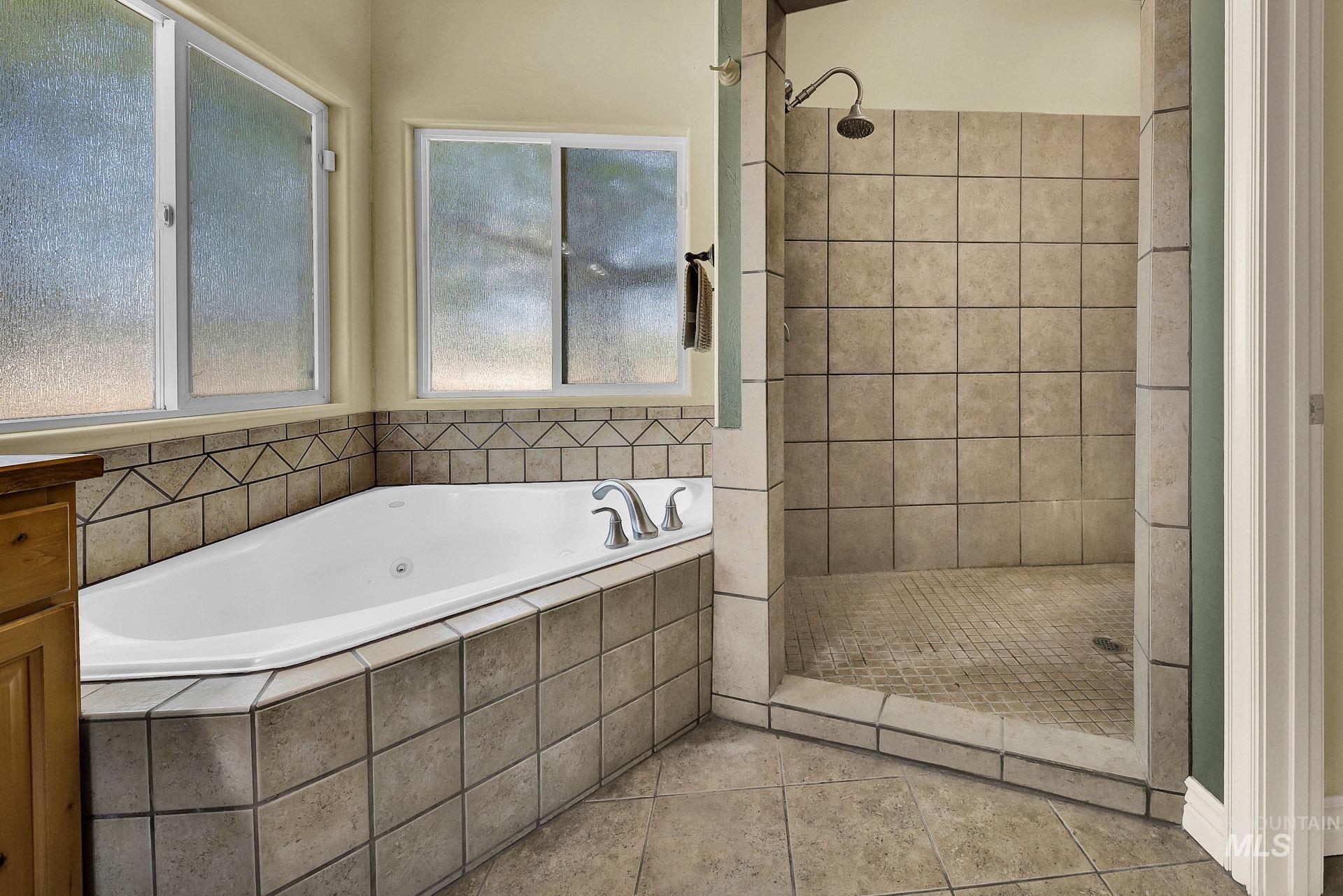 27114 Lower Pleasant Ridge Road Wilder, ID 83676 - Photo 39 of 50 Full bath featuring a garden tub, a tile shower, and tile patterned floors