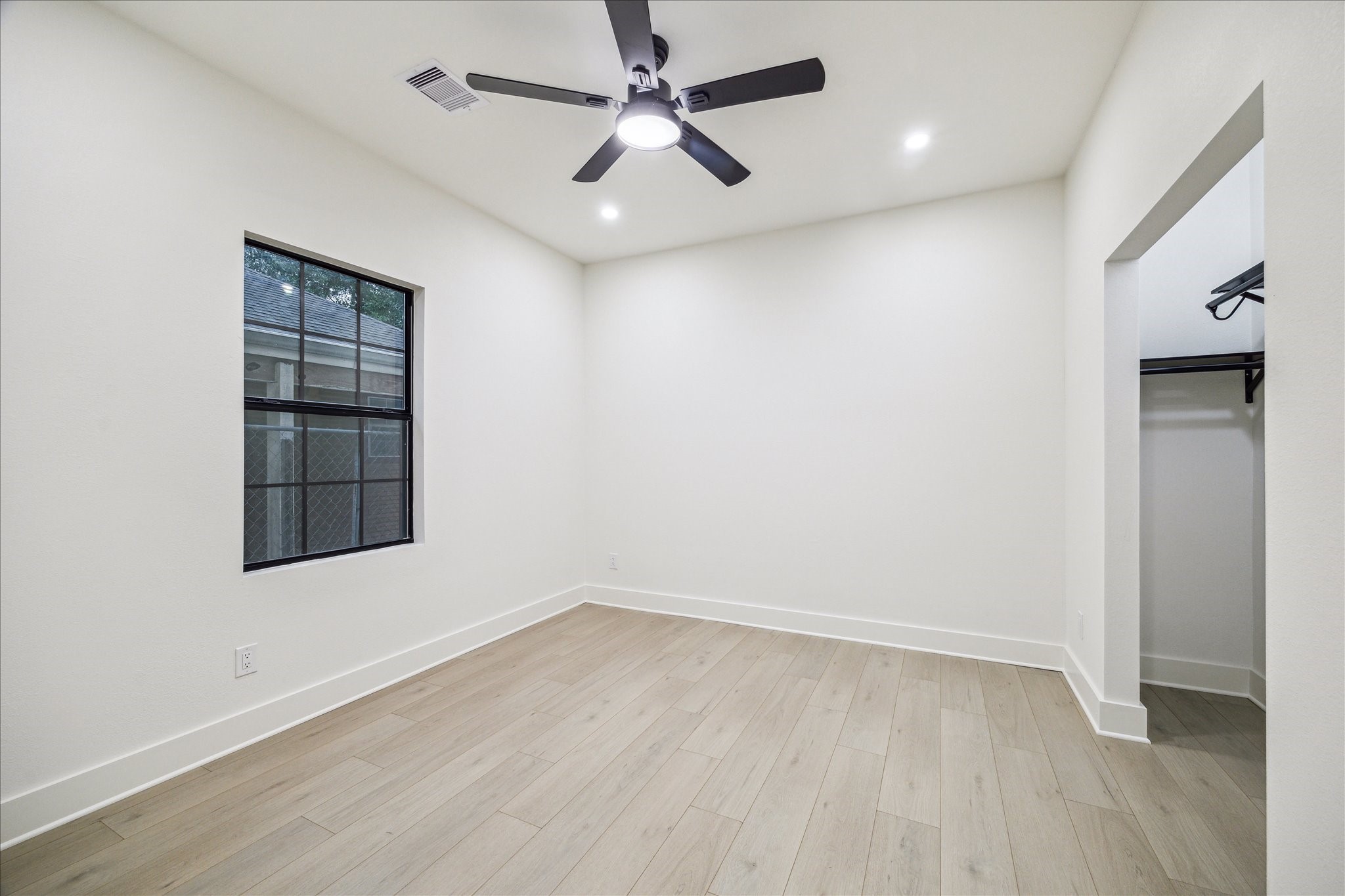 228 Lenox Street Houston, TX 77011 - Photo 11 of 16 wooden floor in an empty room with a window