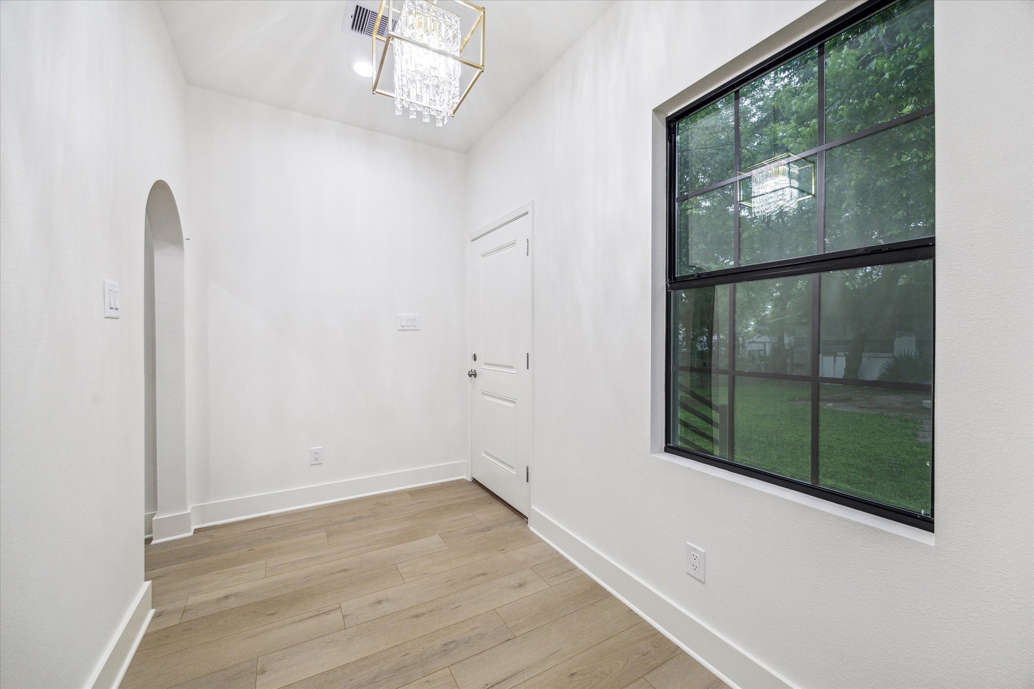 228 Lenox Street Houston, TX 77011 - Photo 14 of 16 an empty room with wooden floor and windows
