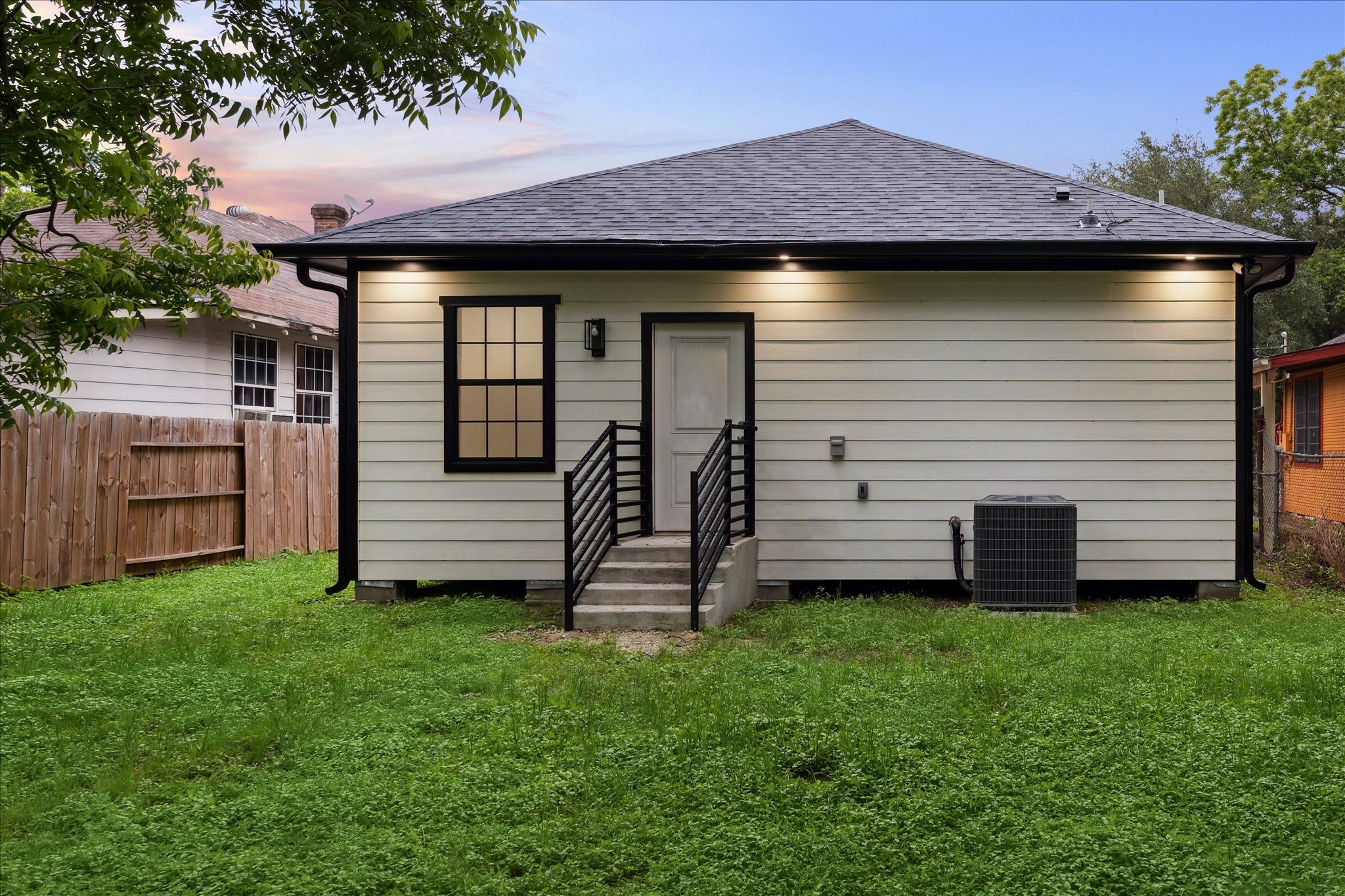 228 Lenox Street Houston, TX 77011 - Photo 15 of 16 a view of a house with a small yard and wooden fence