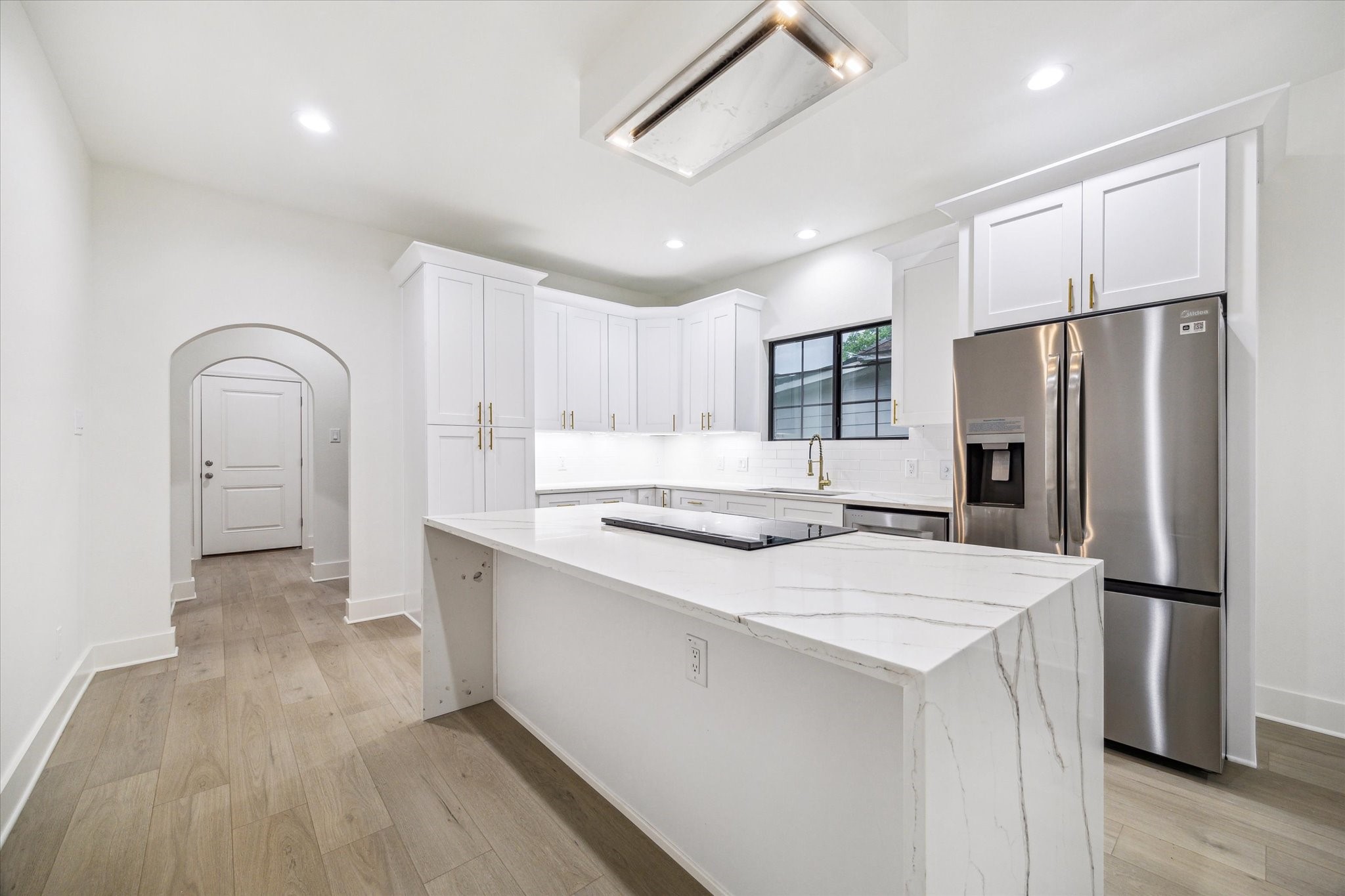 228 Lenox Street Houston, TX 77011 - Photo 5 of 16 a kitchen with stainless steel appliances a refrigerator sink and microwave