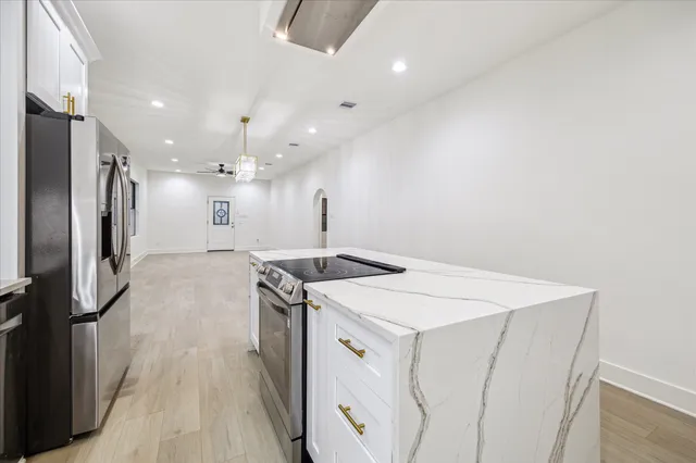 a kitchen with a stove a refrigerator and a sink