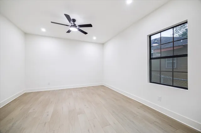 wooden floor in an empty room with a window