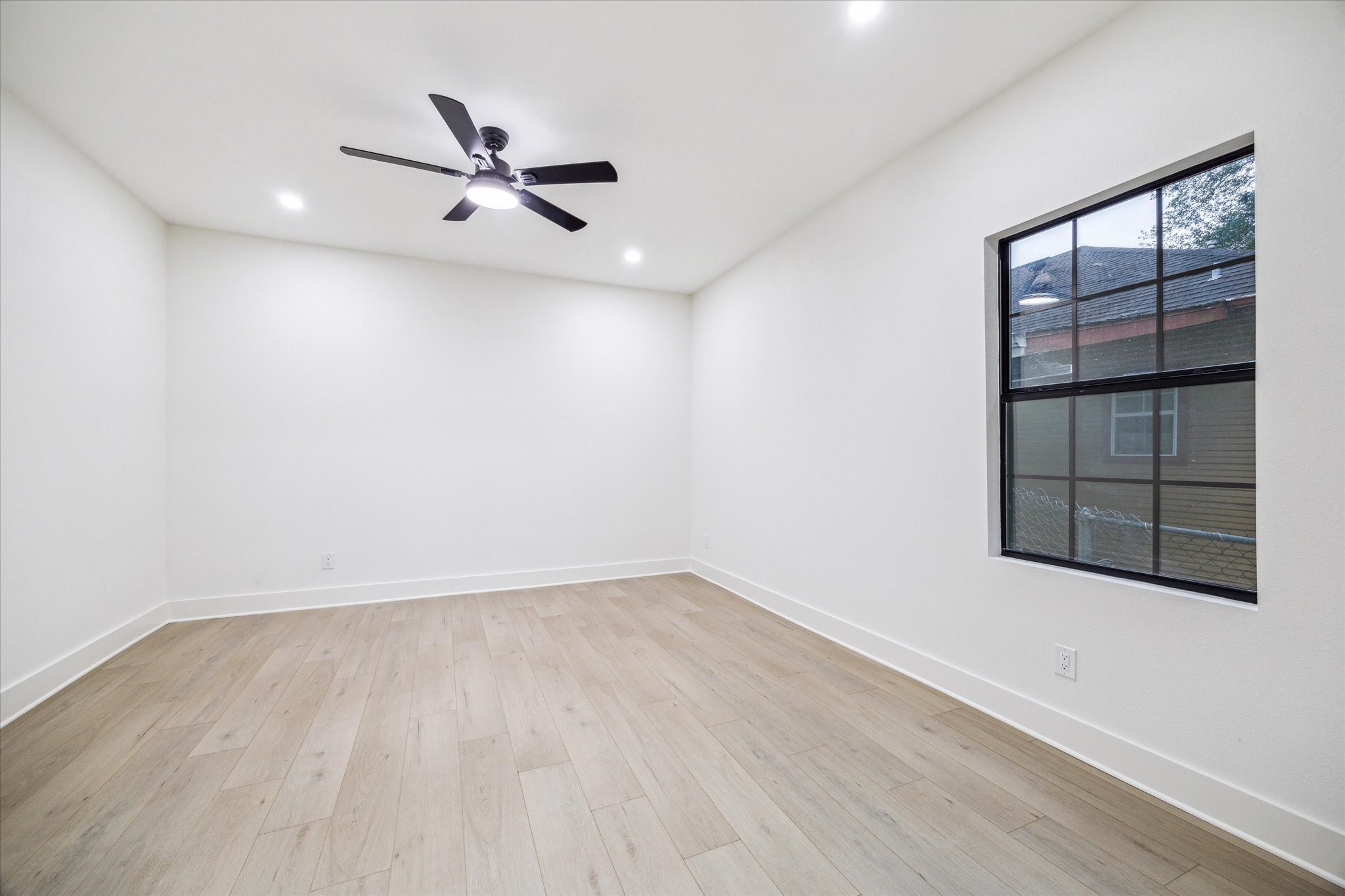 228 Lenox Street Houston, TX 77011 - Photo 8 of 16 wooden floor in an empty room with a window