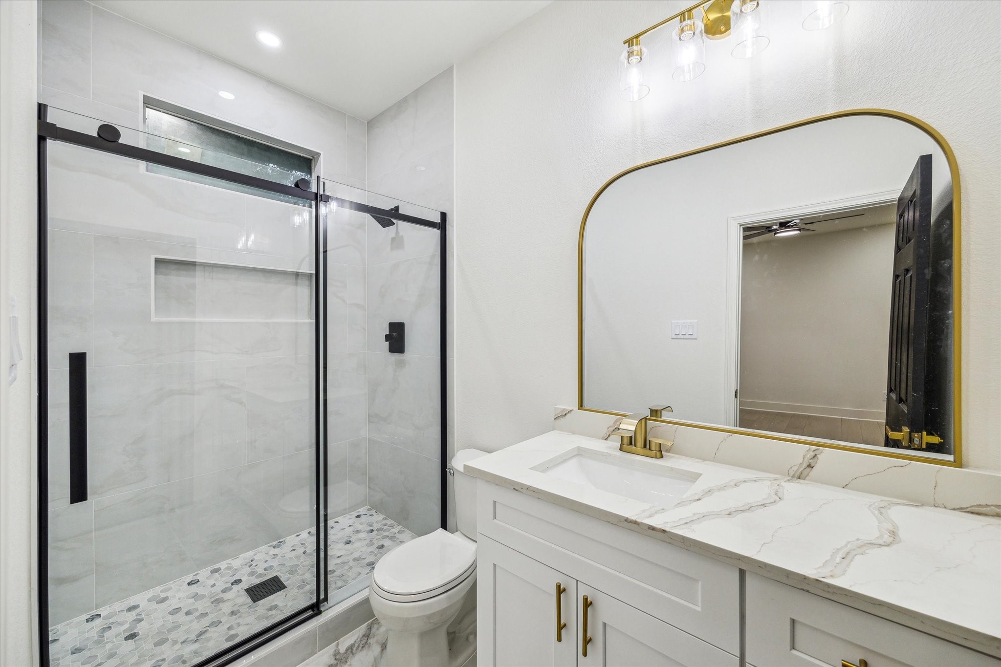 228 Lenox Street Houston, TX 77011 - Photo 9 of 16 a bathroom with a granite countertop sink toilet and shower