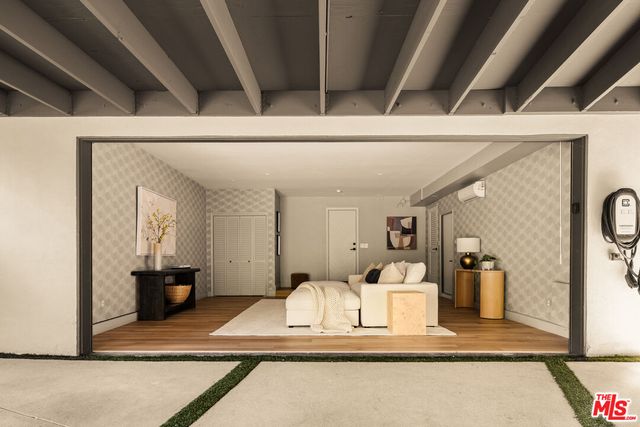 a view of living room with furniture and gym equipment