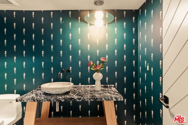 a bathroom with a sink vanity and a mirror