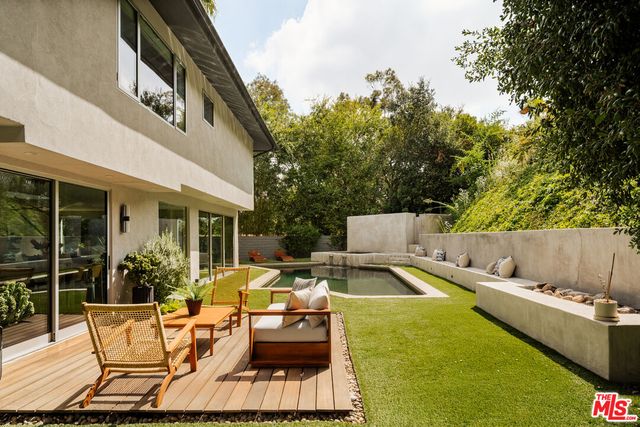 swimming pool view with a seating space