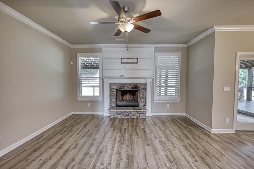 325 Tarpley Way Covington, GA 30016 - Photo 11 of 62 a view of a livingroom with a fireplace a ceiling fan and wooden floor