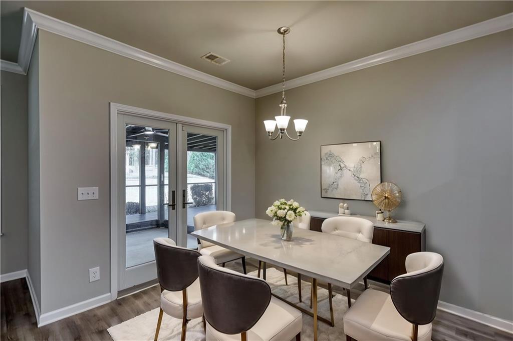 325 Tarpley Way Covington, GA 30016 - Photo 13 of 62 a view of a dining room with furniture a chandelier and wooden floor