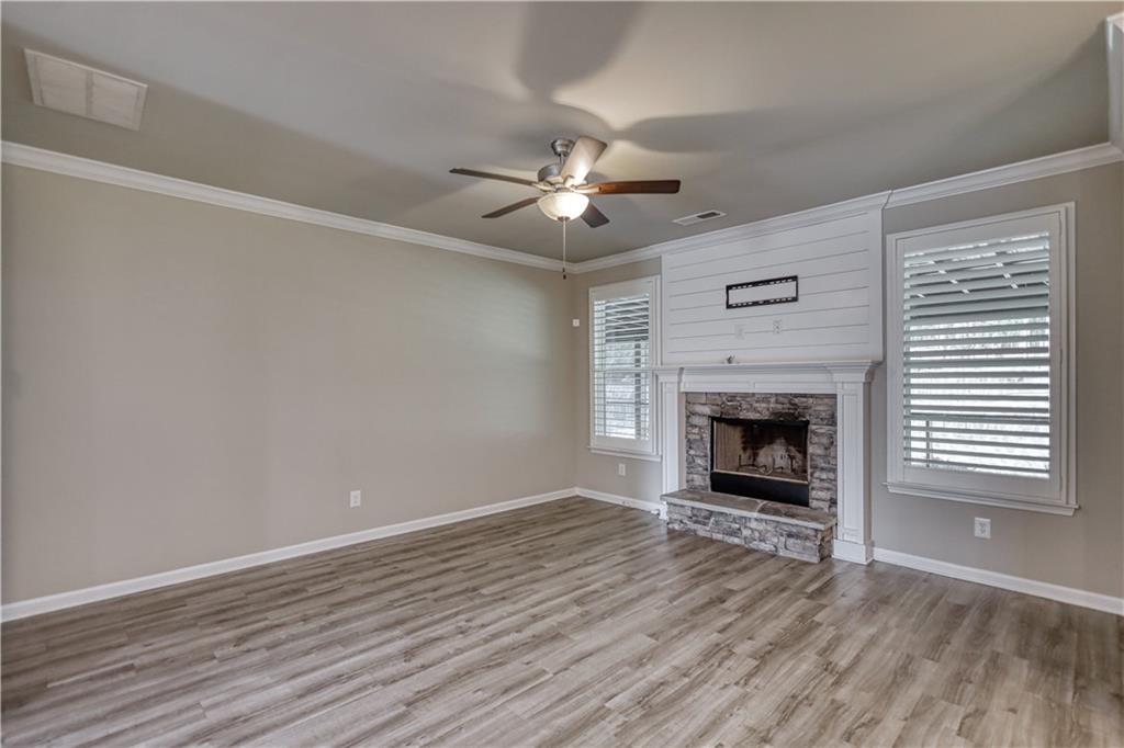325 Tarpley Way Covington, GA 30016 - Photo 14 of 62 wooden floor in an empty room with a fireplace