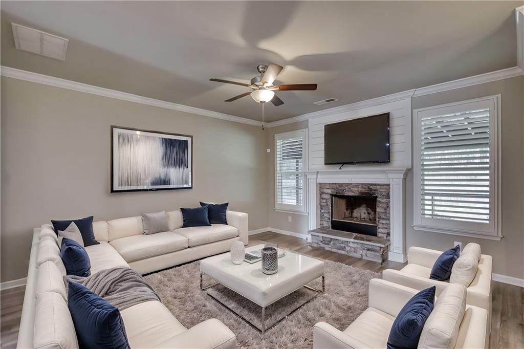325 Tarpley Way Covington, GA 30016 - Photo 15 of 62 a living room with furniture a fireplace and a flat screen tv