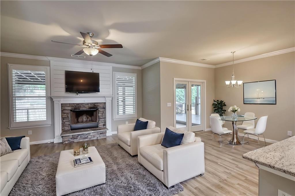 325 Tarpley Way Covington, GA 30016 - Photo 16 of 62 a living room with furniture a flat screen tv and a fireplace
