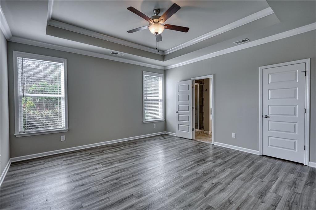 325 Tarpley Way Covington, GA 30016 - Photo 17 of 62 a view of an empty room with a window and wooden floor