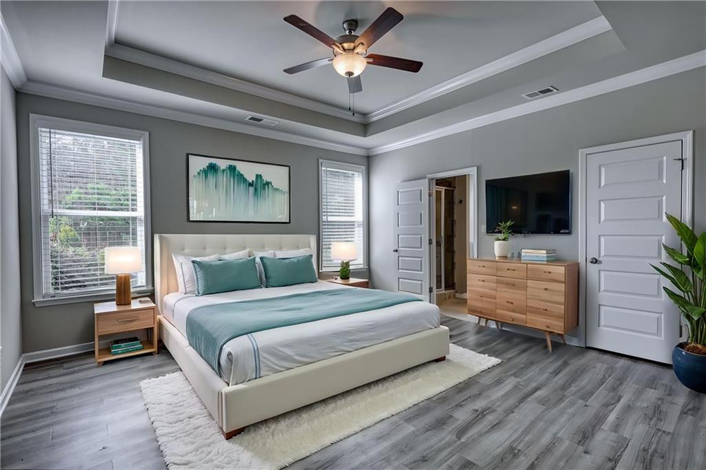 325 Tarpley Way Covington, GA 30016 - Photo 18 of 62 a bedroom with a bed and a flat screen tv