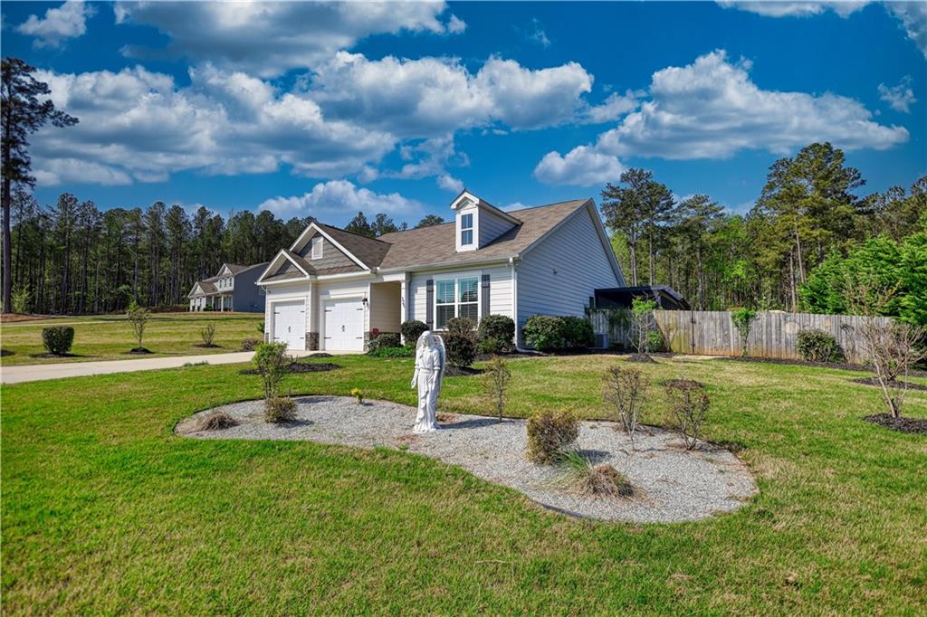 325 Tarpley Way Covington, GA 30016 - Photo 2 of 62 a view of a house with a big yard and a large tree