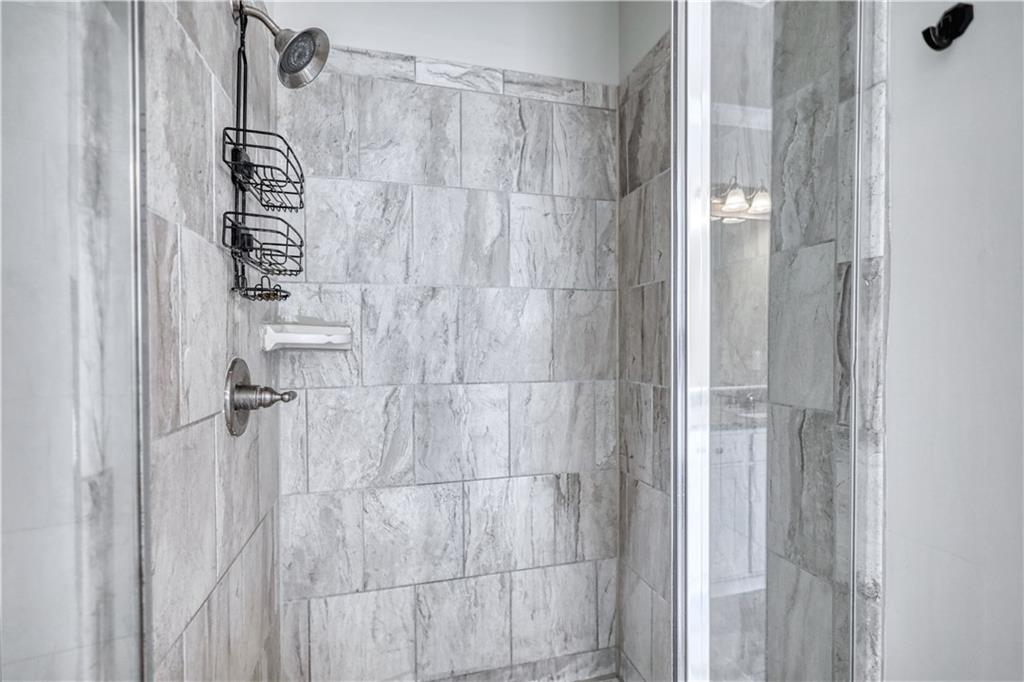 325 Tarpley Way Covington, GA 30016 - Photo 22 of 62 a bathroom with a shower