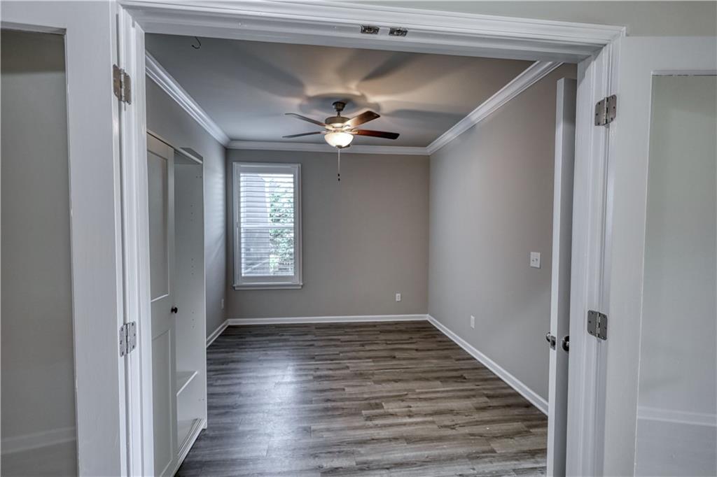 325 Tarpley Way Covington, GA 30016 - Photo 24 of 62 a view of a hallway with wooden floor and chandelier