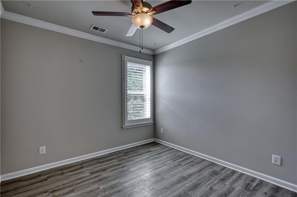 325 Tarpley Way Covington, GA 30016 - Photo 26 of 62 an empty room with a window and a fan