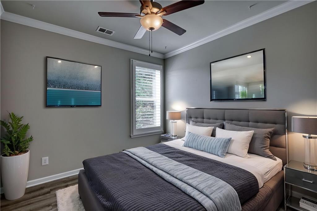 325 Tarpley Way Covington, GA 30016 - Photo 27 of 62 a bedroom with a bed and a potted plant