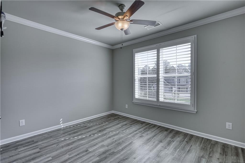 325 Tarpley Way Covington, GA 30016 - Photo 28 of 62 a view of an empty room with a window and wooden floor