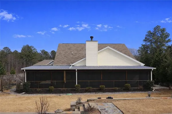 a front view of house with a yard and parking space