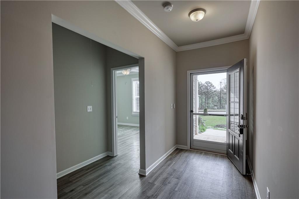 325 Tarpley Way Covington, GA 30016 - Photo 31 of 62 an empty room with wooden floor and windows