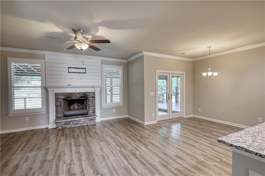 325 Tarpley Way Covington, GA 30016 - Photo 34 of 62 a view of an empty room with wooden floor fireplace and a window