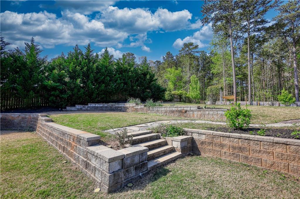 325 Tarpley Way Covington, GA 30016 - Photo 45 of 62 a view of a swimming pool with a patio