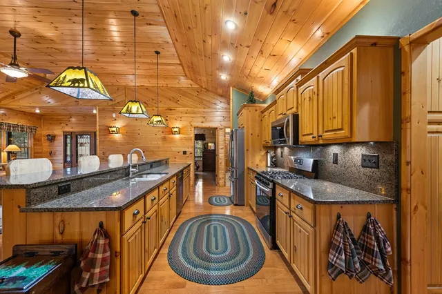 a kitchen with stainless steel appliances granite countertop a sink and cabinets