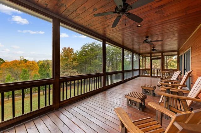 a balcony with wooden floor and outdoor seating