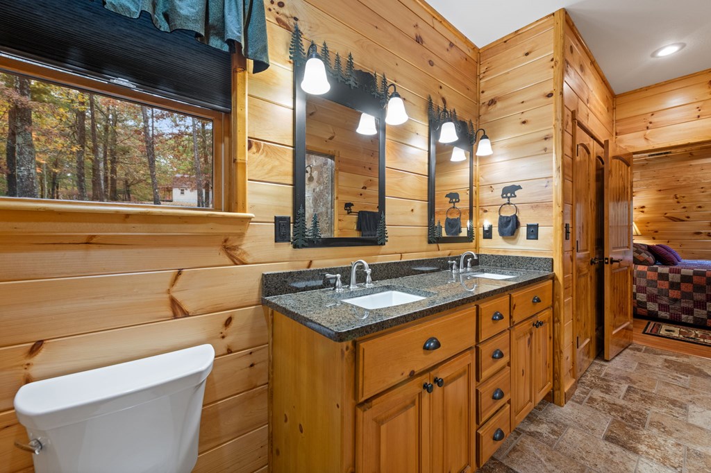 34 Smokey Ridge Lane Morganton, GA 30560 - Photo 19 of 47 a bathroom with a granite countertop sink and a large mirror